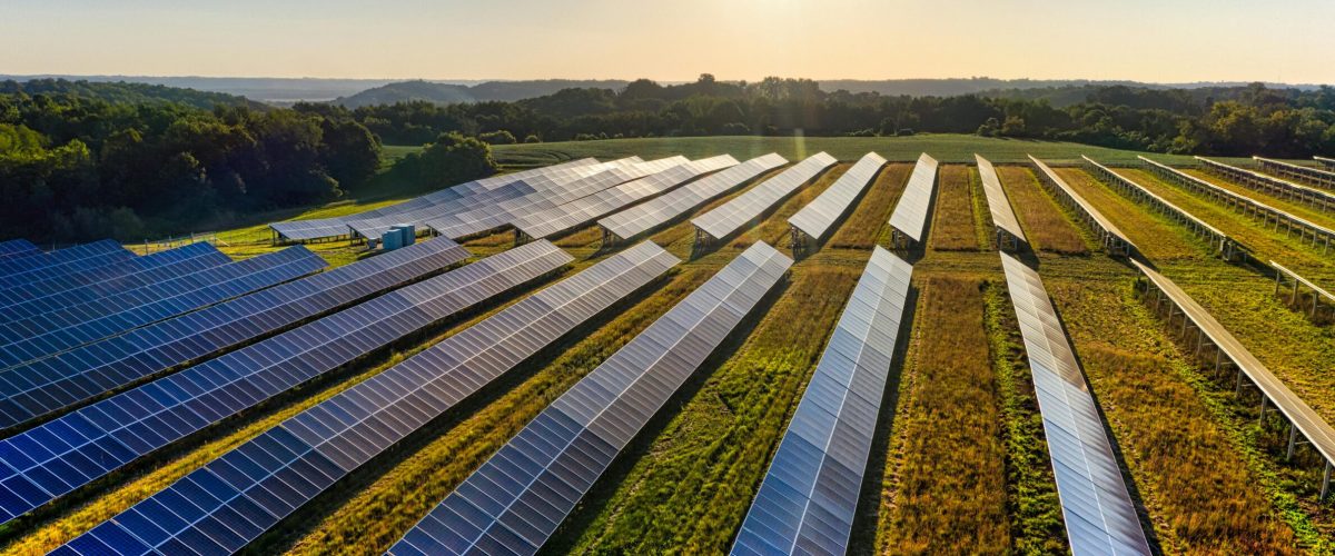 Aerial view of a solar farm in Red Wing, MN, with solar panels harnessing the sun's energy.